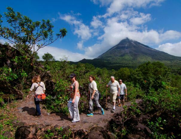 people hiking near arenal volcano